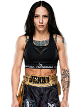 Jenny Savage wearing a black sports bra and black shorts with visible branding on a white background