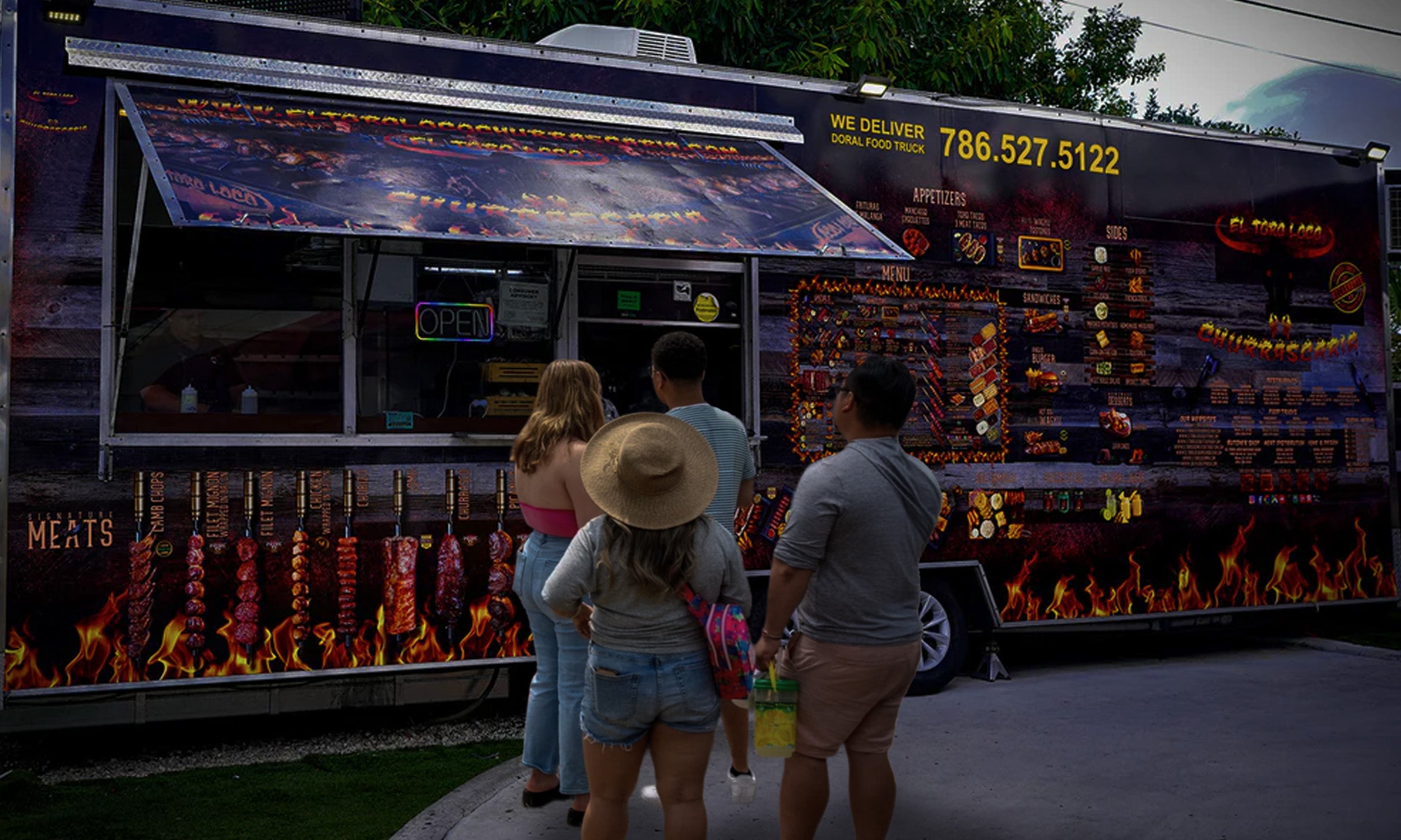 People standing in front of El Toro Loco food truck with menu boards displayed.