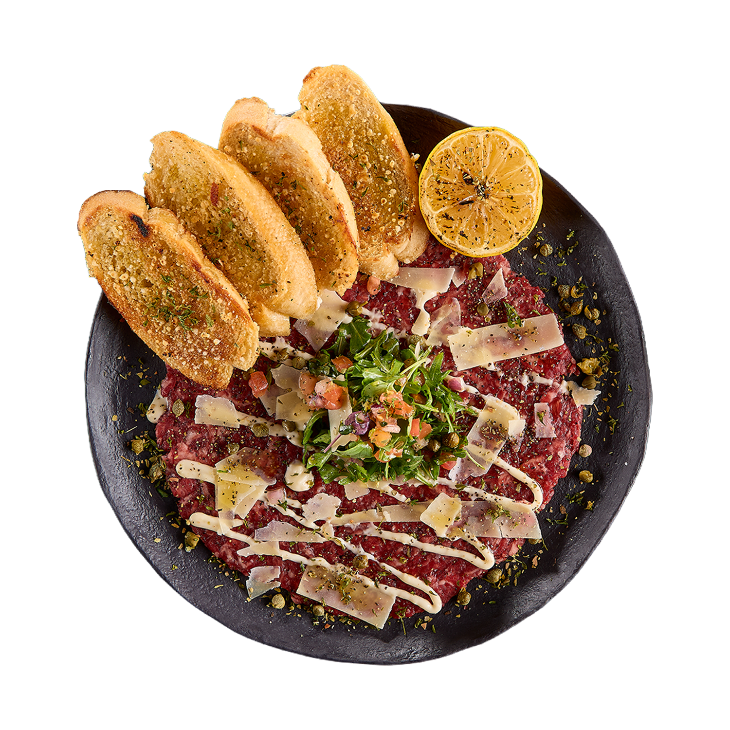Plated beef tartare with bread and lemon on a white background