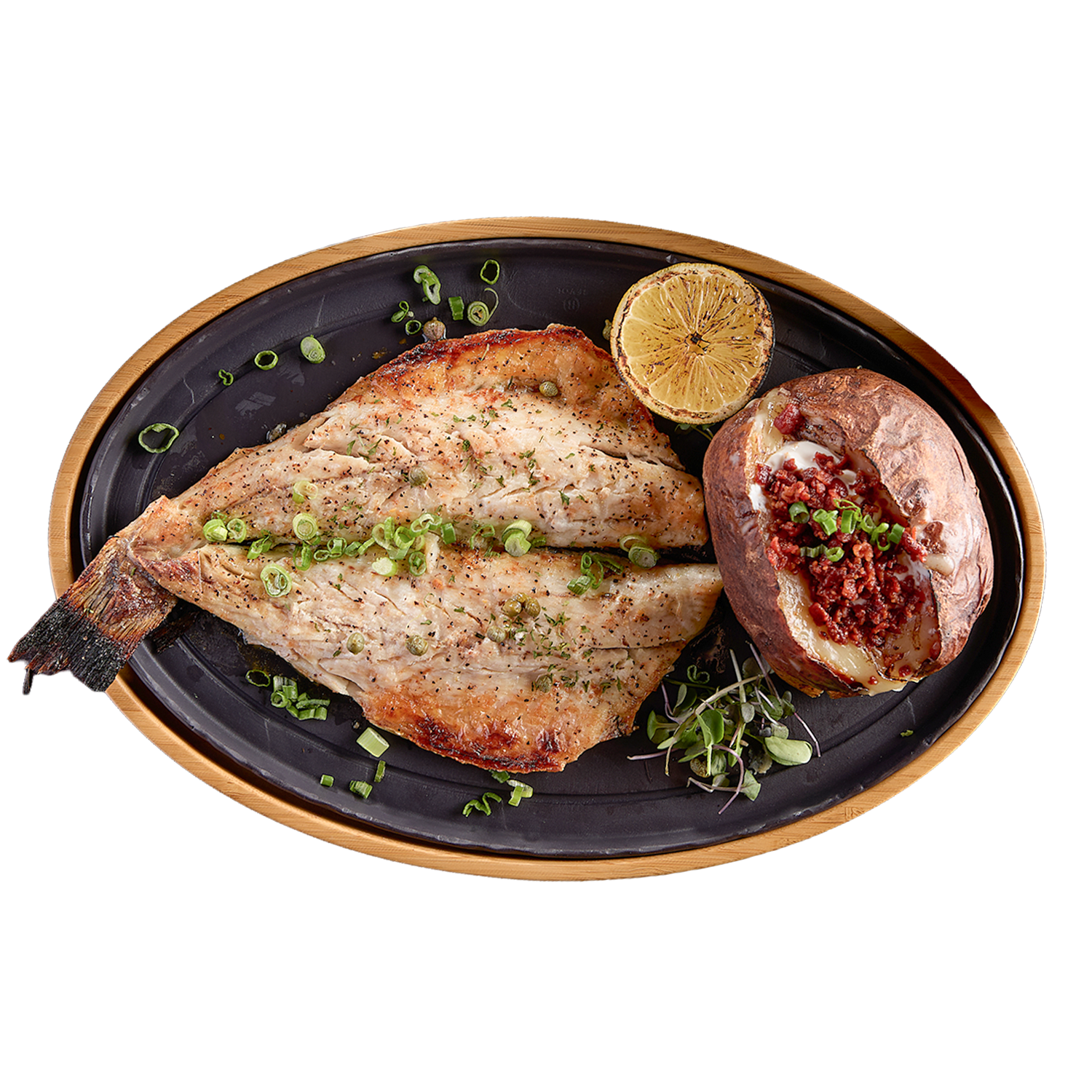 Plated dish with branzino and baked potato on a white background
