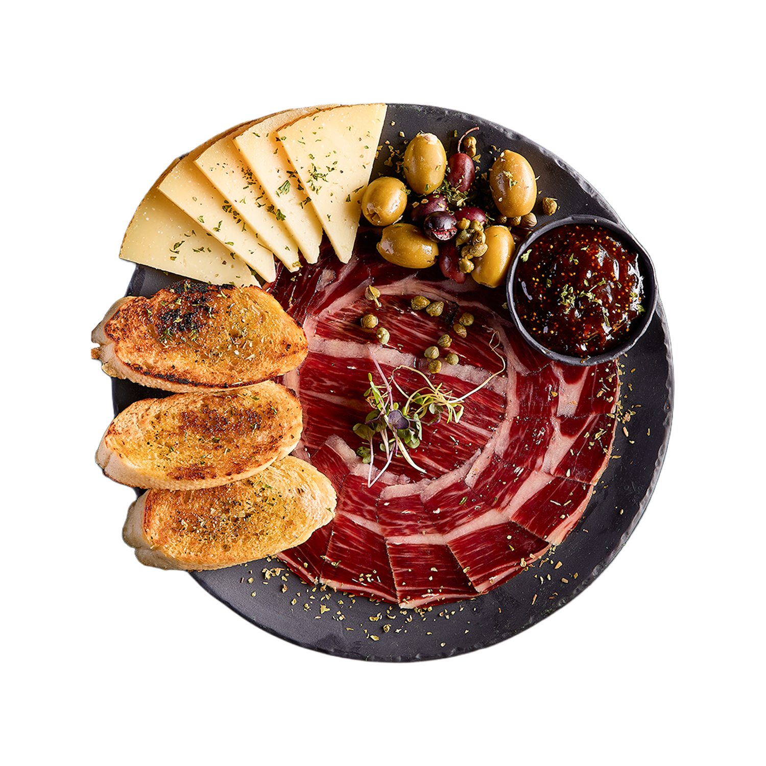 Platter with sliced ham, cheese, bread, olives, and a small bowl of condiment on a white background